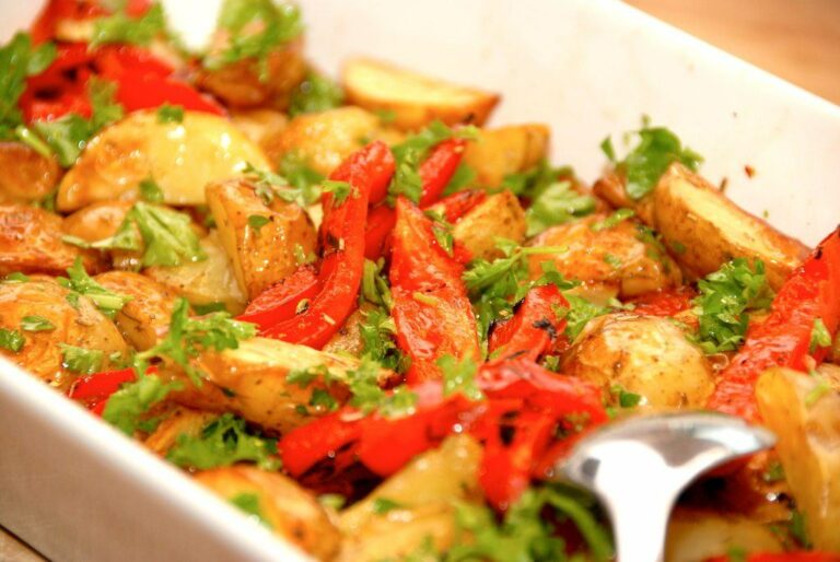 En virkelig lækker kartoffelsalat med grillede peberfrugter og eddikedressing, der vendes med hakket persille. Kartoffelsalaten er god til grillet kød, men er også et hit til frikadeller eller koteletter. Foto: Madensverden.dk.