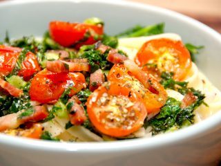 Lækker pasta med grønkål, hvor grønkålen steges let sammen med sprøde stykker bacon. Serveres med bagte tomater. Foto: Madensverden.dk.